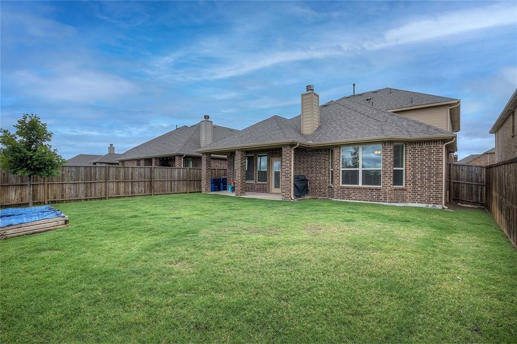Newer brick home with a large fenced backyard in the Rockwall, TX area