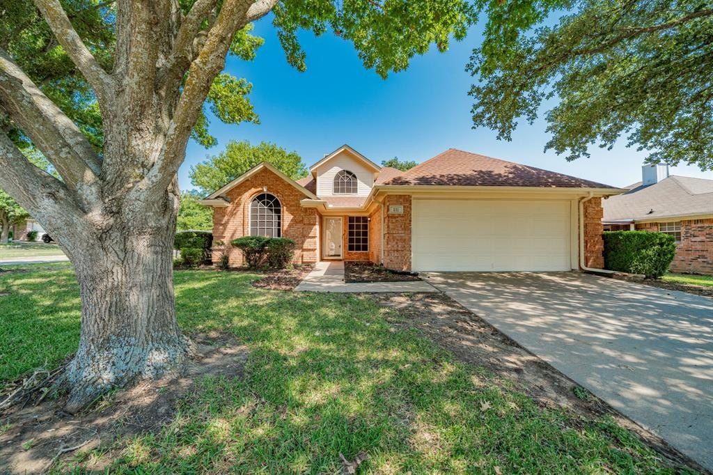 Brick family home under a mature shade tree in the Rockwall, TX area