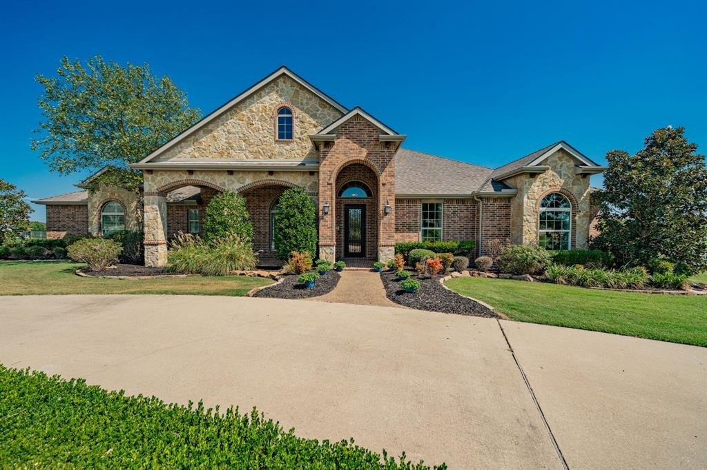 Stone and brick home with arched entry in the Rockwall, TX area